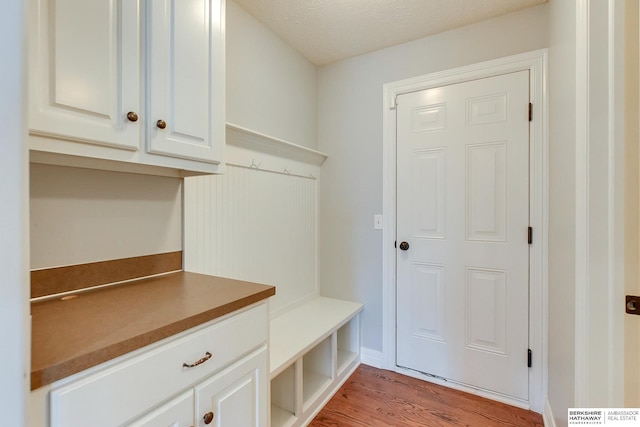 mudroom featuring light hardwood / wood-style floors and a textured ceiling