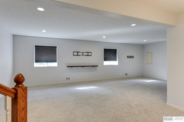 unfurnished living room with light carpet and a healthy amount of sunlight