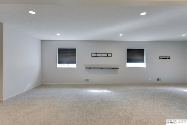 carpeted spare room featuring plenty of natural light