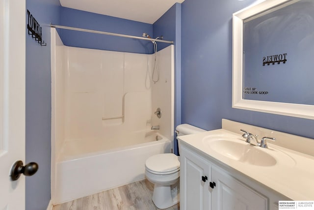 full bathroom featuring vanity, bathtub / shower combination, hardwood / wood-style floors, and toilet