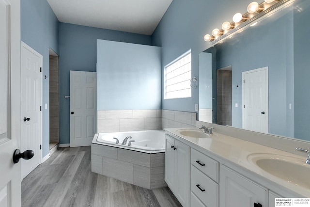 bathroom featuring vanity, hardwood / wood-style floors, and separate shower and tub