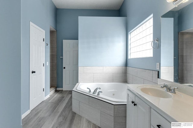 bathroom with vanity, shower with separate bathtub, and hardwood / wood-style floors