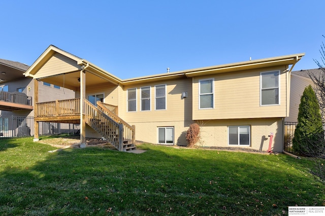 rear view of house with a deck and a lawn