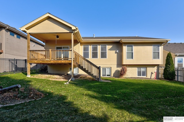 rear view of house featuring a yard and a deck