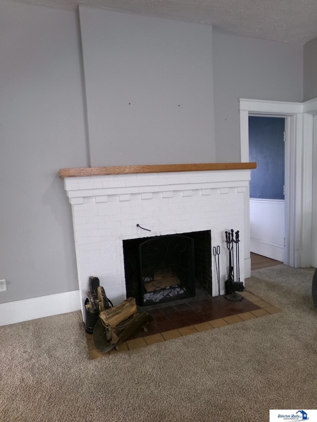 room details featuring a fireplace, a textured ceiling, and carpet