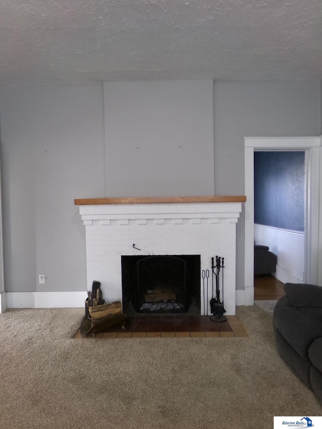 room details featuring a fireplace, carpet floors, and a textured ceiling