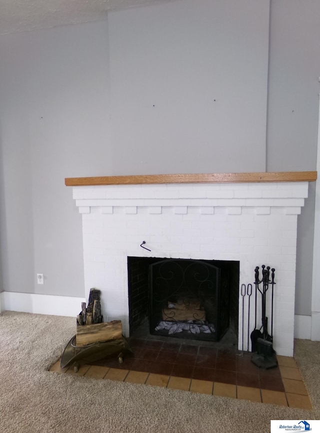 room details with a brick fireplace and carpet flooring