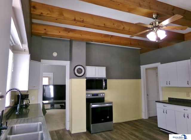 kitchen with beam ceiling, stainless steel appliances, dark wood-type flooring, and a sink