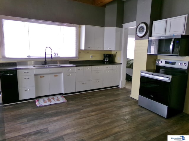 kitchen with a sink, stainless steel appliances, and white cabinetry