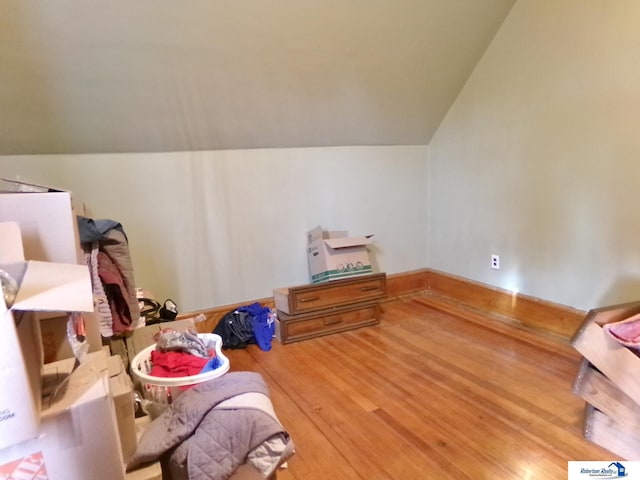 bonus room featuring vaulted ceiling and wood finished floors