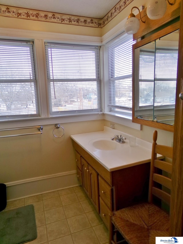 bathroom featuring tile patterned floors, vanity, and baseboards