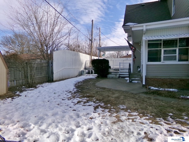 snowy yard with fence