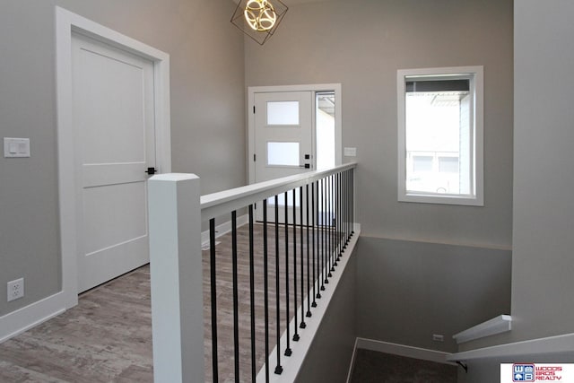 stairs featuring hardwood / wood-style floors