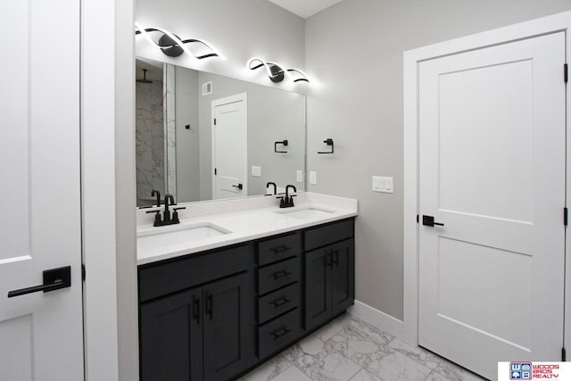 bathroom featuring walk in shower and vanity