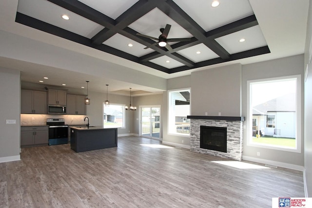 unfurnished living room with coffered ceiling, hardwood / wood-style flooring, and sink