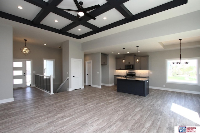 kitchen featuring hanging light fixtures, an island with sink, and hardwood / wood-style floors