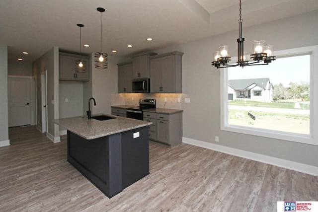 kitchen featuring hanging light fixtures, gray cabinetry, and stainless steel appliances