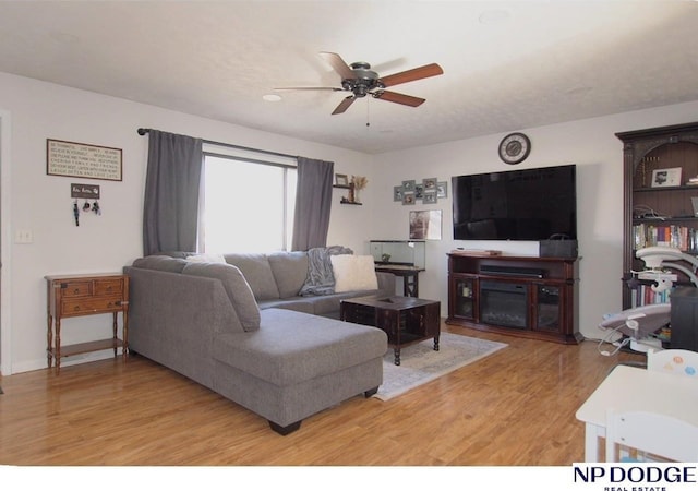 living room featuring wood-type flooring and ceiling fan