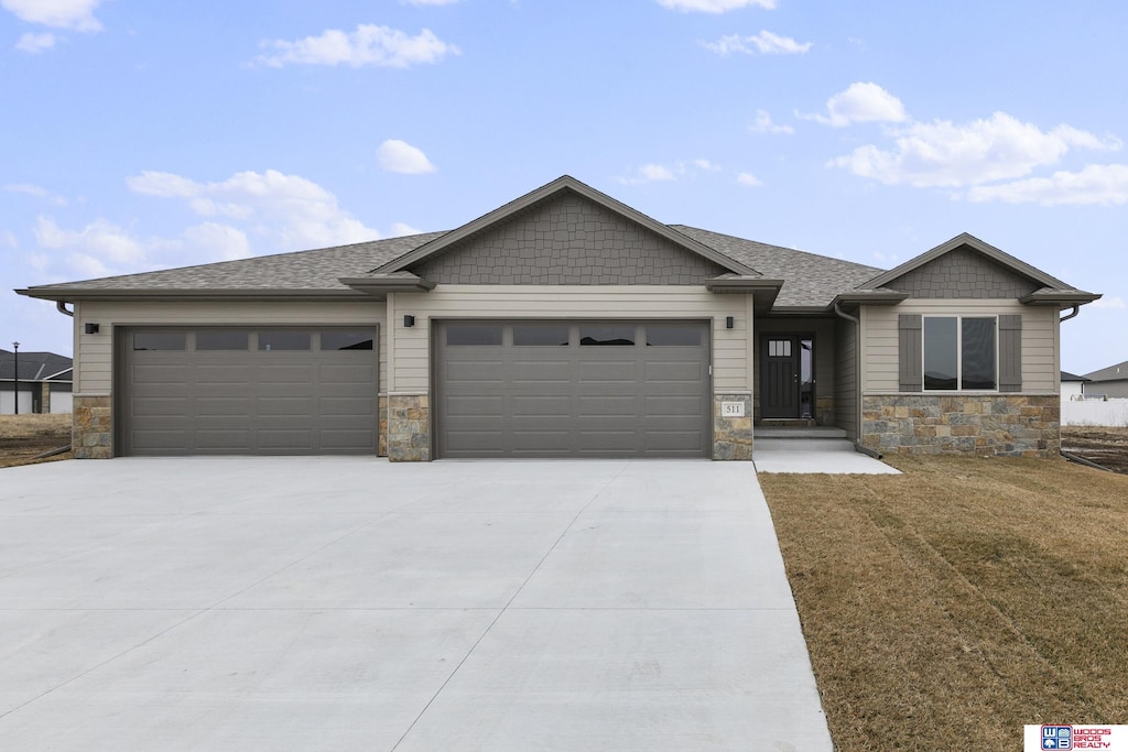 view of front of property with a front yard and a garage