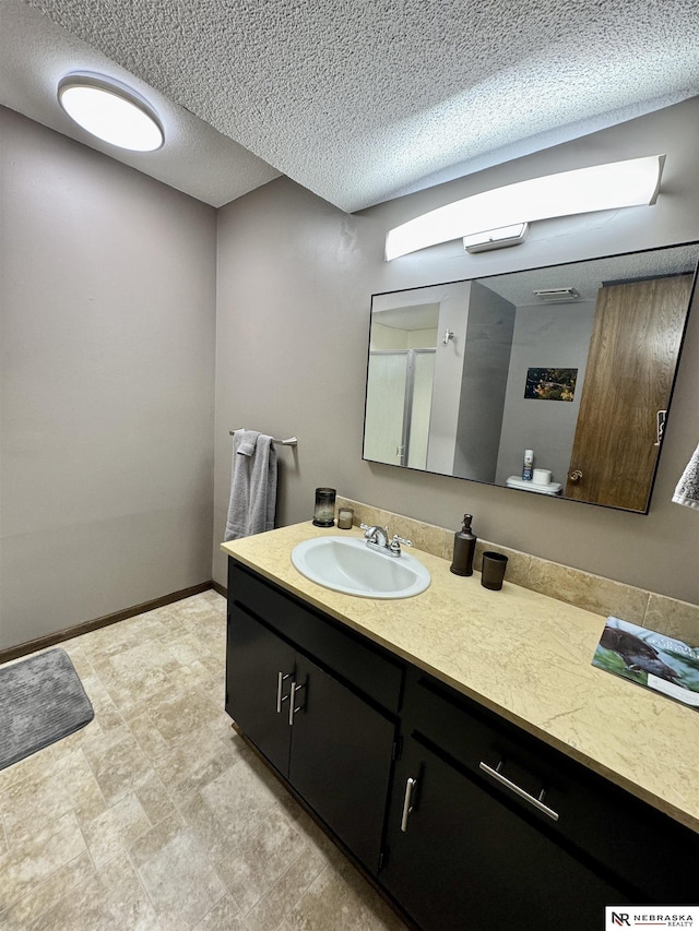 bathroom featuring vanity and a textured ceiling