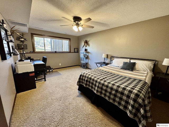 bedroom featuring a textured ceiling, ceiling fan, and carpet