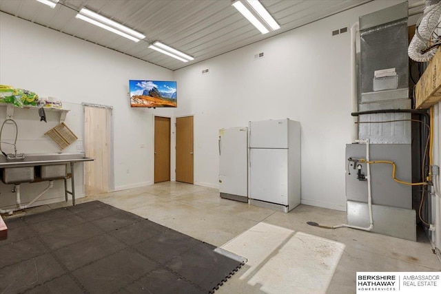 miscellaneous room featuring high vaulted ceiling