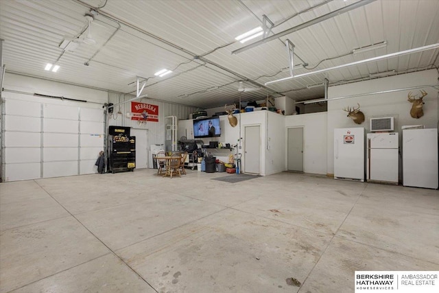 garage featuring white fridge and fridge