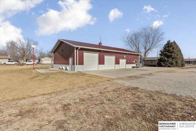 view of home's exterior featuring a garage, a yard, and an outdoor structure