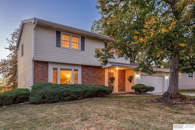 view of front of property featuring a garage and a front lawn