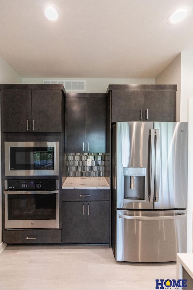 kitchen with light wood-type flooring and stainless steel appliances