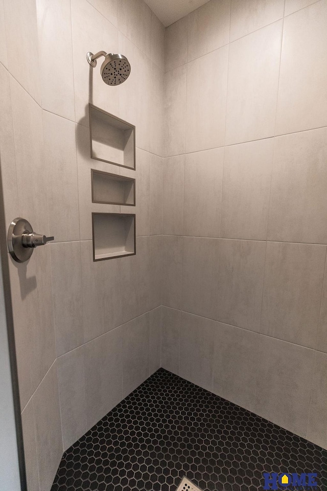 bathroom with a tile shower