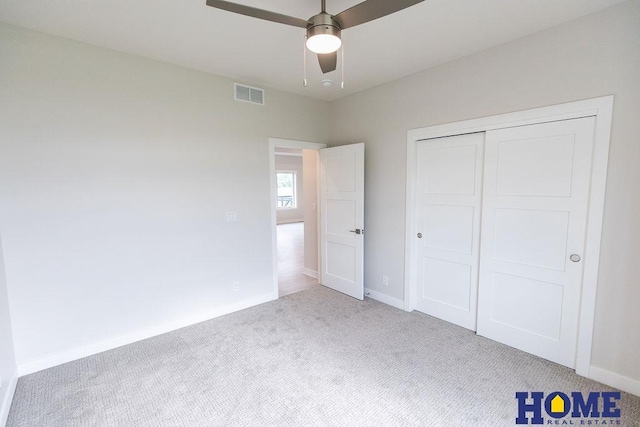 unfurnished bedroom featuring ceiling fan, a closet, and carpet floors