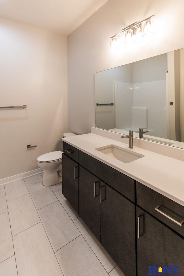 bathroom featuring tile patterned floors, toilet, and vanity