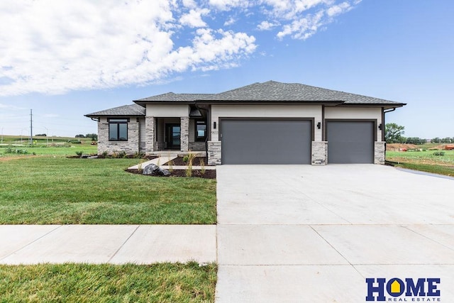 prairie-style house with a front yard and a garage