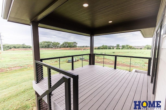 wooden terrace featuring a rural view and a yard