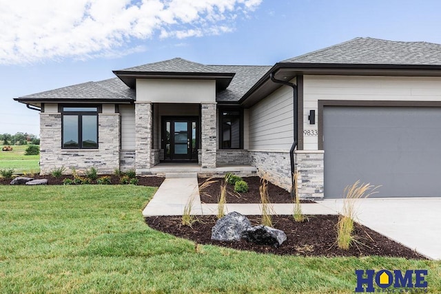 view of front of property with a front yard and a garage