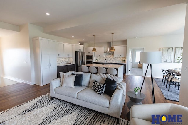 living room featuring hardwood / wood-style flooring and sink