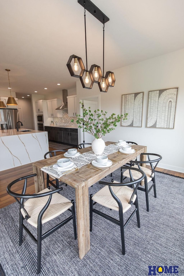 dining room with hardwood / wood-style flooring and sink