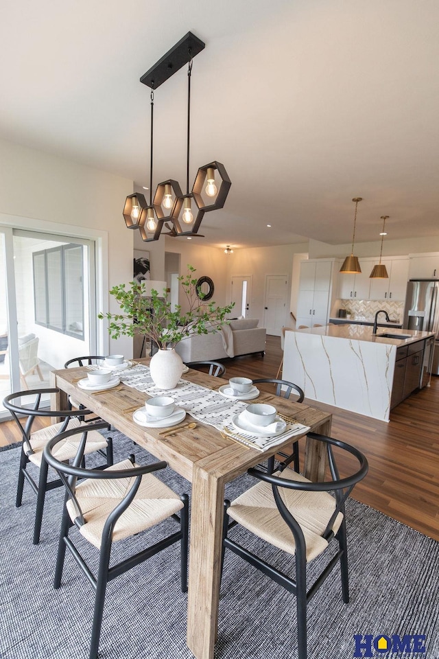 dining area with dark hardwood / wood-style floors and sink