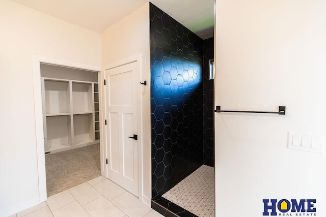 bathroom with tile patterned floors and a tile shower