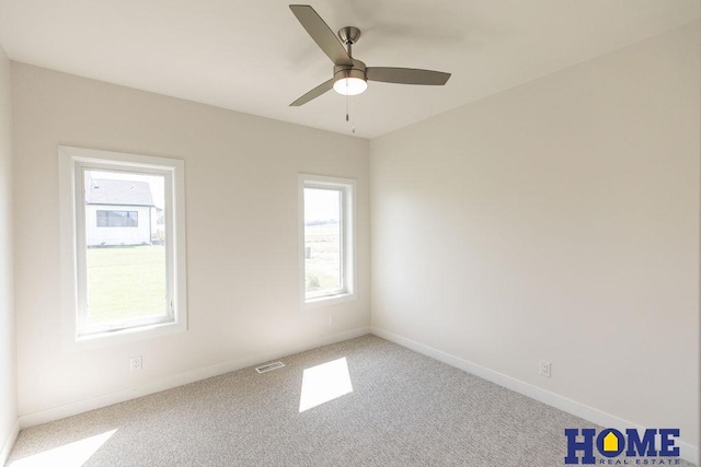 empty room with ceiling fan, carpet flooring, and a healthy amount of sunlight