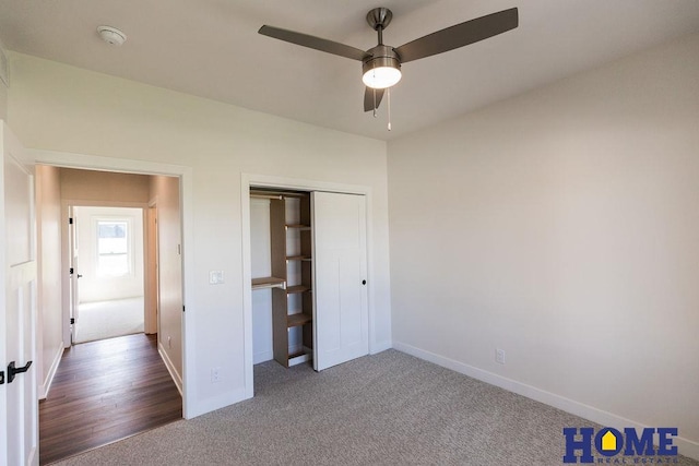 unfurnished bedroom with ceiling fan, a closet, and carpet