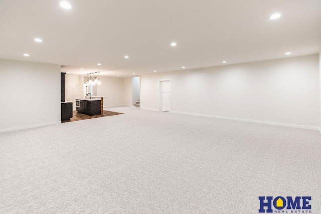 basement featuring light colored carpet