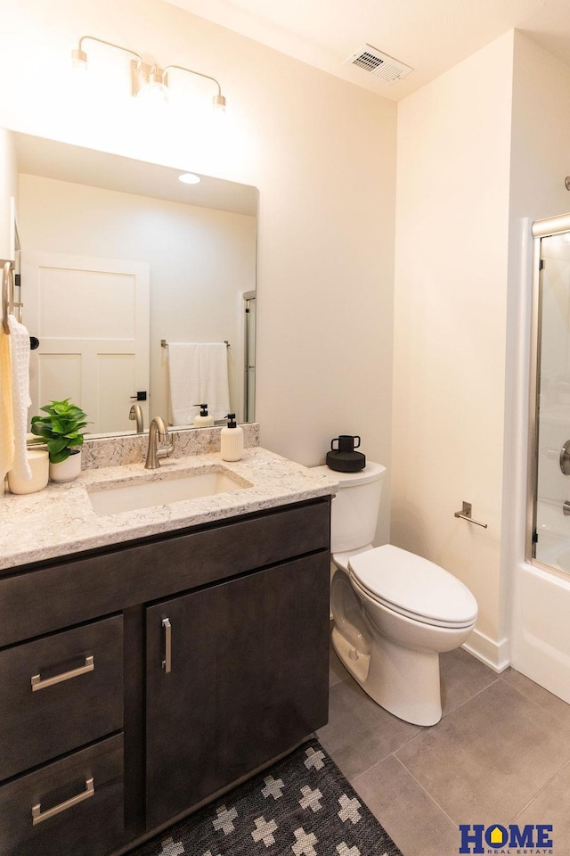 full bathroom featuring tile patterned floors, toilet, vanity, and shower / bath combination with glass door