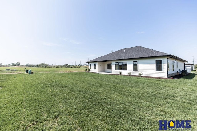 back of property featuring central air condition unit, a yard, and a patio