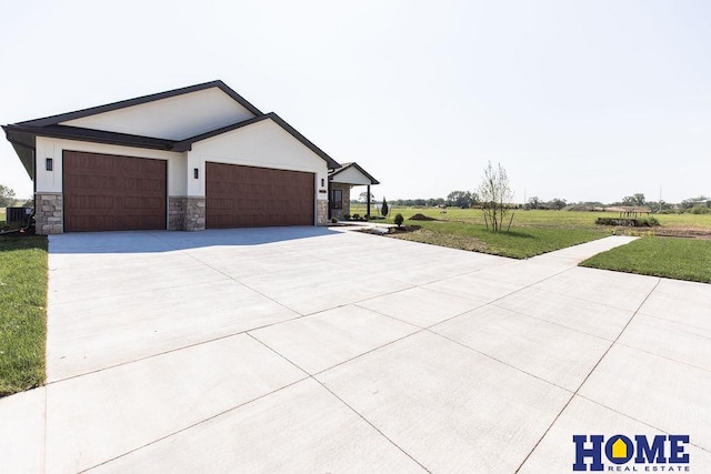 view of front of house with a garage, a front yard, and central AC unit