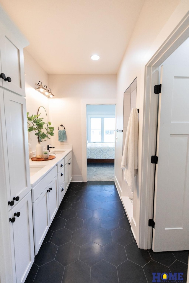 bathroom with tile patterned floors and vanity