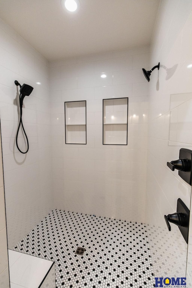 bathroom with tile patterned flooring and tiled shower