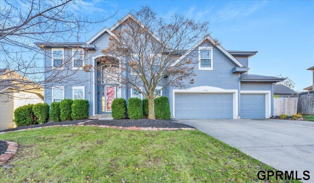 view of property with a front yard and a garage