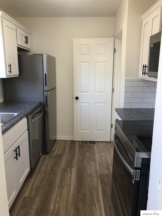 kitchen featuring white cabinetry, backsplash, range with electric cooktop, and dishwasher